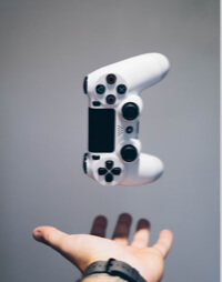 game controller in the air above a hand